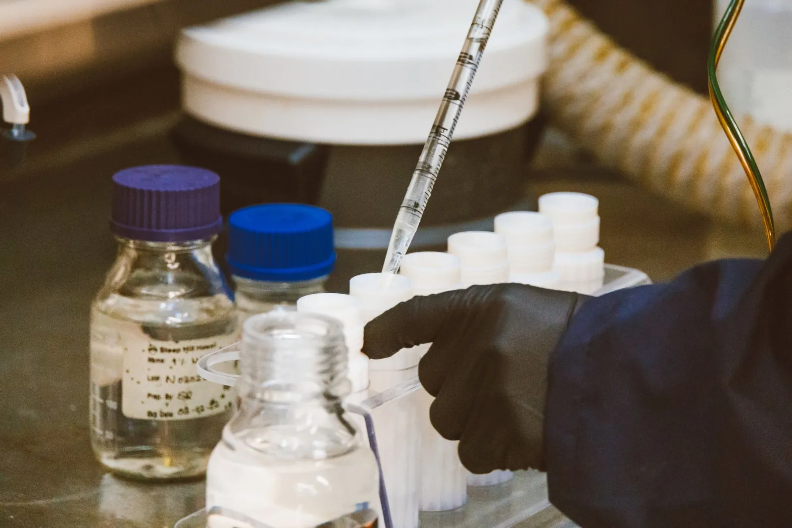 Detailed view of laboratory equipment and pipette in use, enhancing scientific research. Stock photo illustrating Godavari Biorefineries' regulatory approval story.