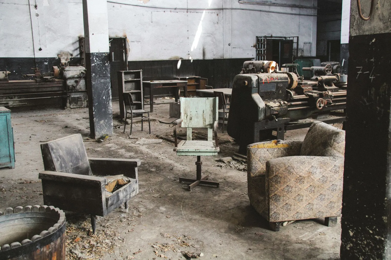 Explore an abandoned industrial space filled with vintage furniture and machinery, highlighting urban decay. Stock photo illustrating Nilkamal's financial results story.