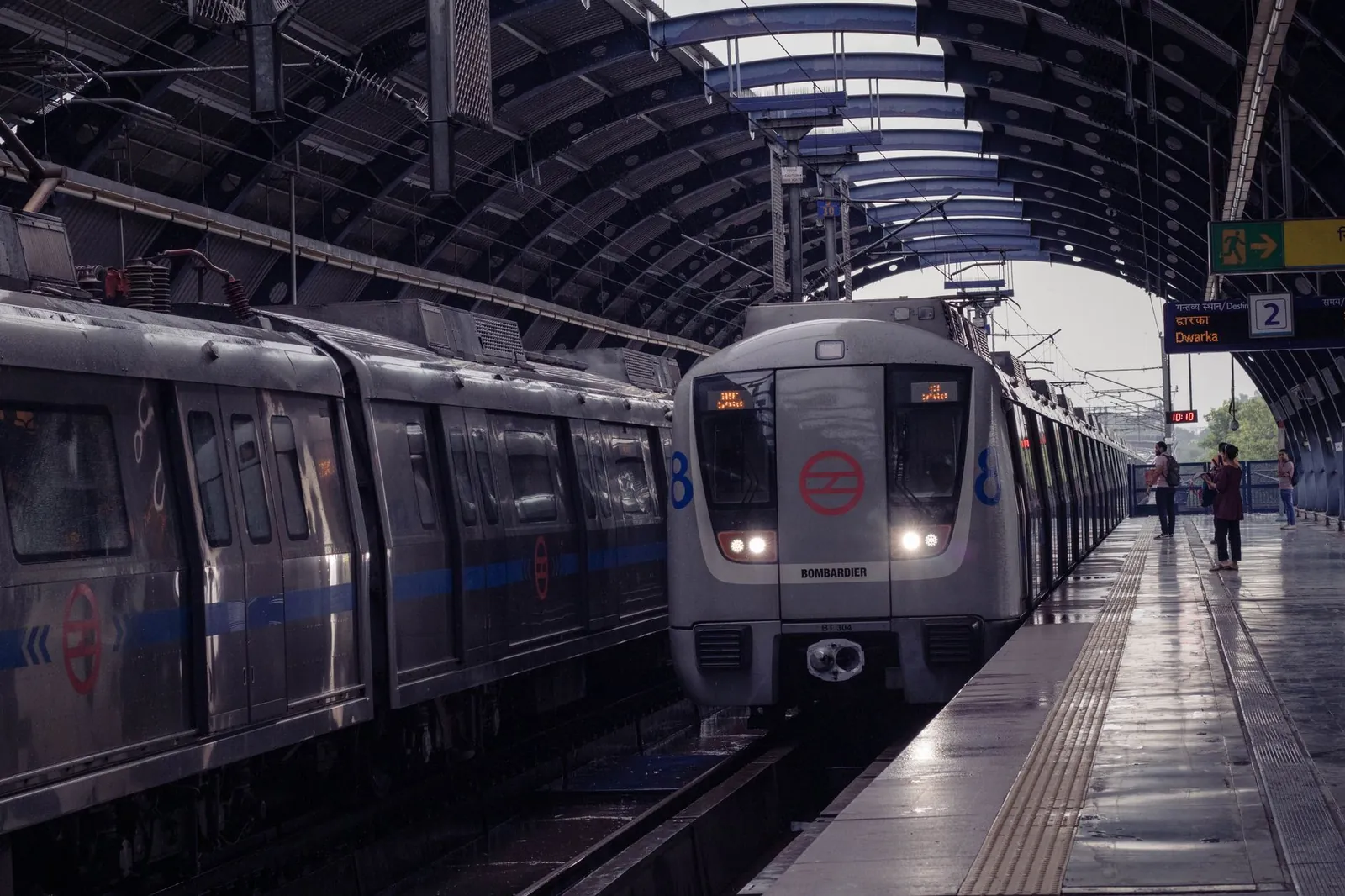 A Delhi Metro train arrives at an indoor station platform capturing urban transit life. Stock photo illustrating BEML's earning call story.