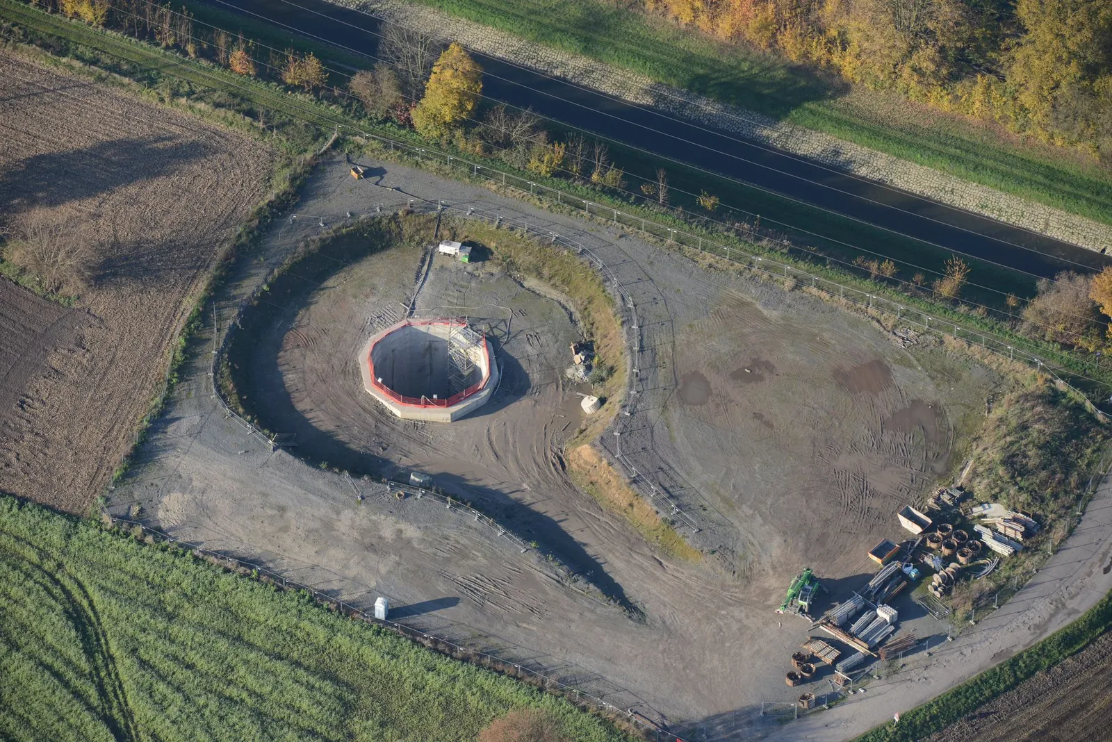Aerial view of a small construction site amidst fields and trees during autumn. Stock photo illustrating Sattva Engineering Construction's new order story.