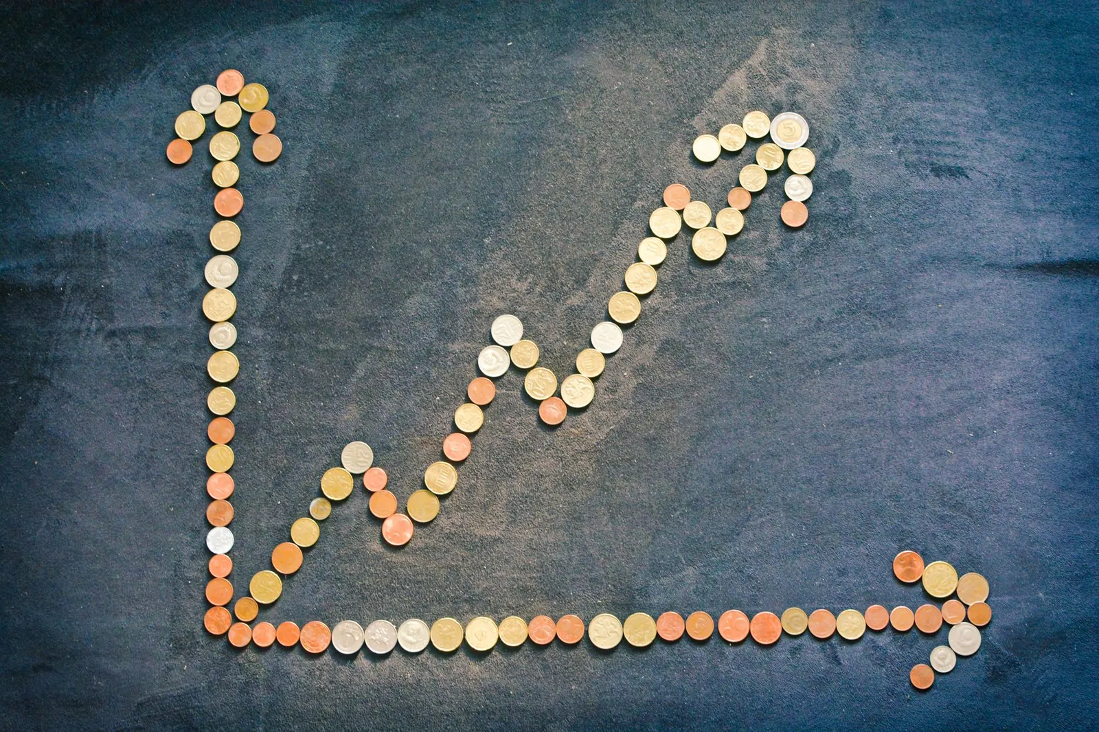 An upward trend graph made from coins representing financial growth and success. Stock photo illustrating Nisus Finance Services Co's earning call story.