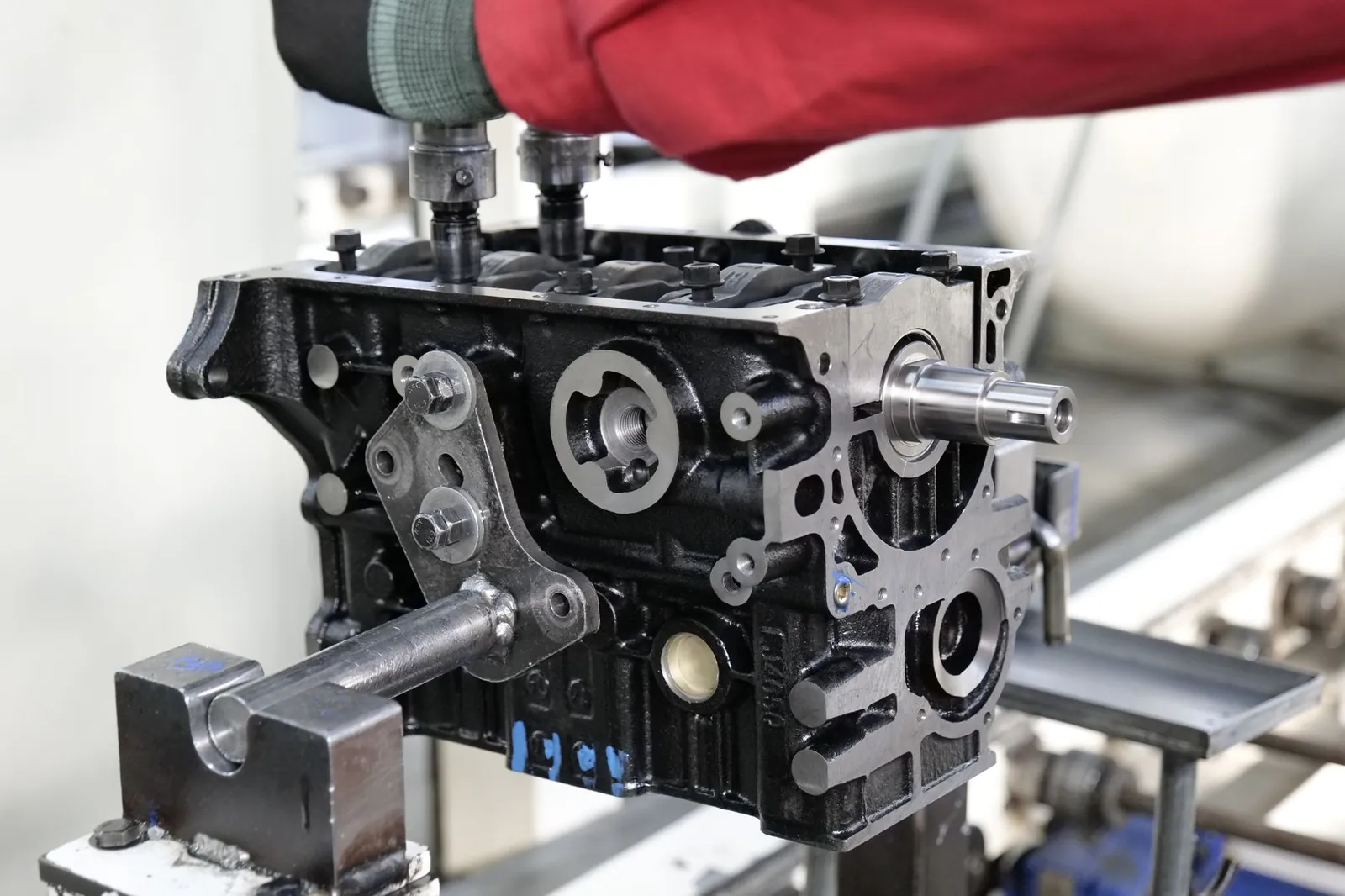 Close-up of engine assembly process highlighting industrial precision. Stock photo illustrating Raymond's fund raise story.