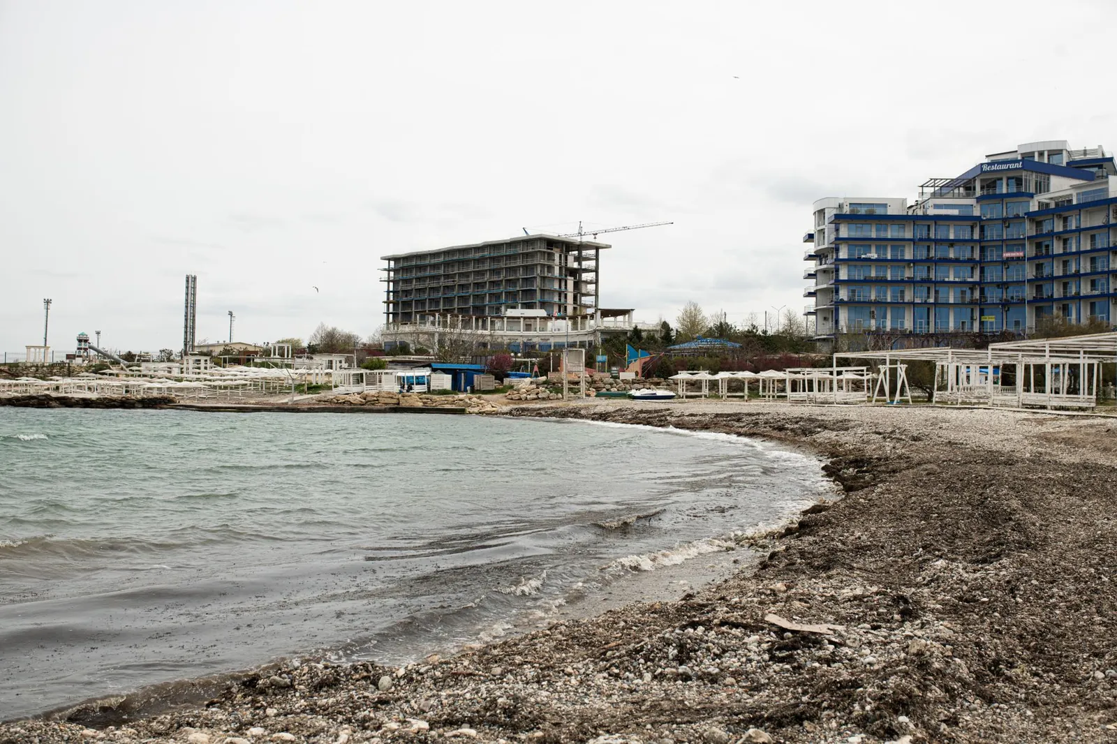 Beachfront construction site and resort buildings along the Sevastopol coastline. Stock photo illustrating Chavda Infra's new order story.