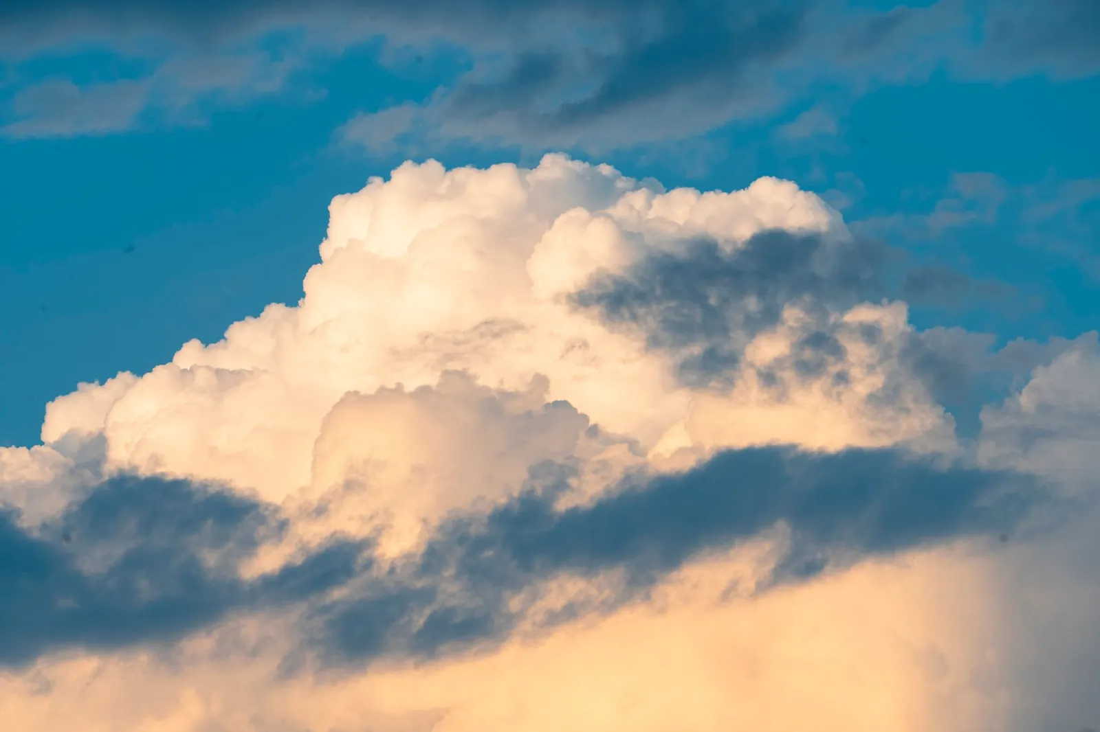 A stunning cumulus cloud formation with dramatic lighting against a bright blue sky. Stock photo illustrating Tata Consultancy Services' product launched story.