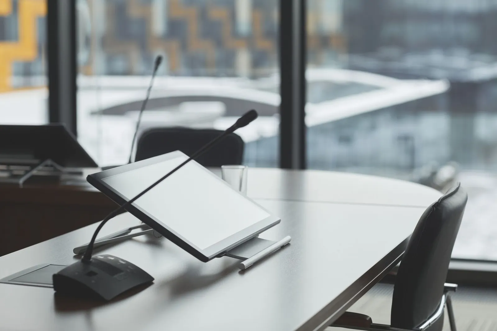High-tech conference room with digital tablets and microphones for effective communication. Stock photo illustrating Praruh Technologies' new order story.