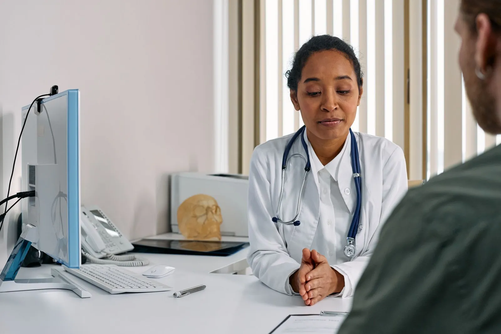 A female doctor consulting a patient in a modern medical office setting. Stock photo illustrating Sun Pharmaceutical Industries' regulatory approval story.