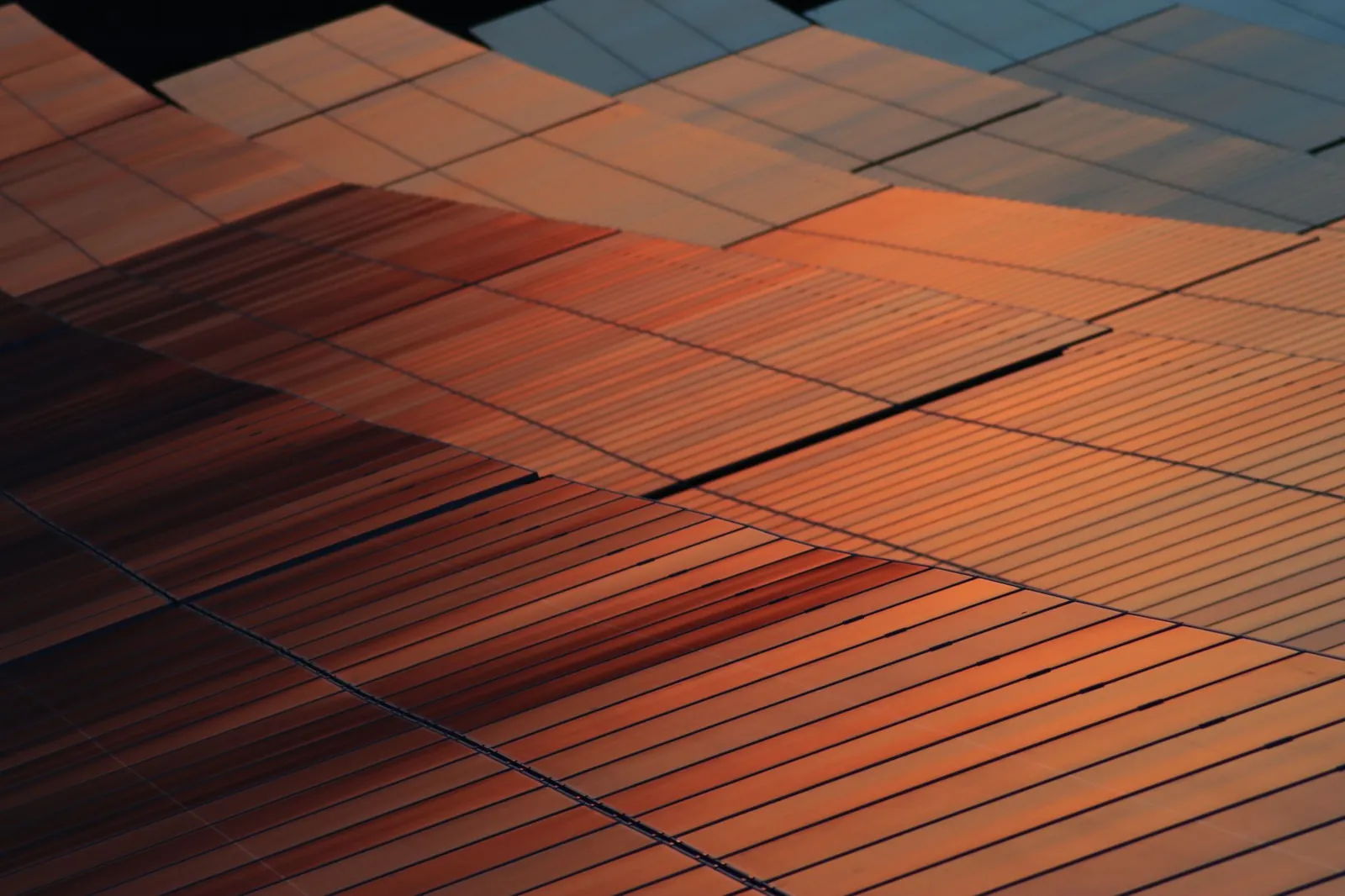 Close-up view of solar panels reflecting sunset light, illustrating renewable energy technology. Stock photo illustrating Alpex Solar's earning call story.