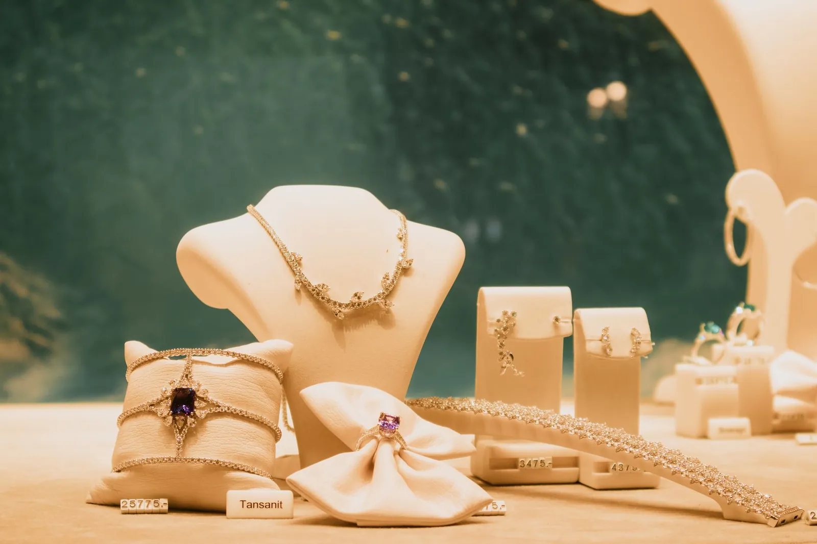 Luxury jewelry set elegantly displayed with necklaces and rings in a store setting. Stock photo illustrating P N Gadgil Jewellers' fund raise story.