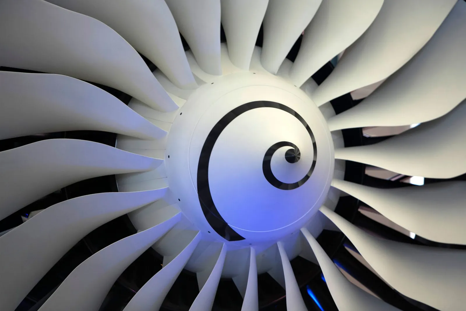 High-resolution image of a jet engine turbine blade, showcasing intricate details and curvature. Stock photo illustrating Azad Engineering's expansion story.