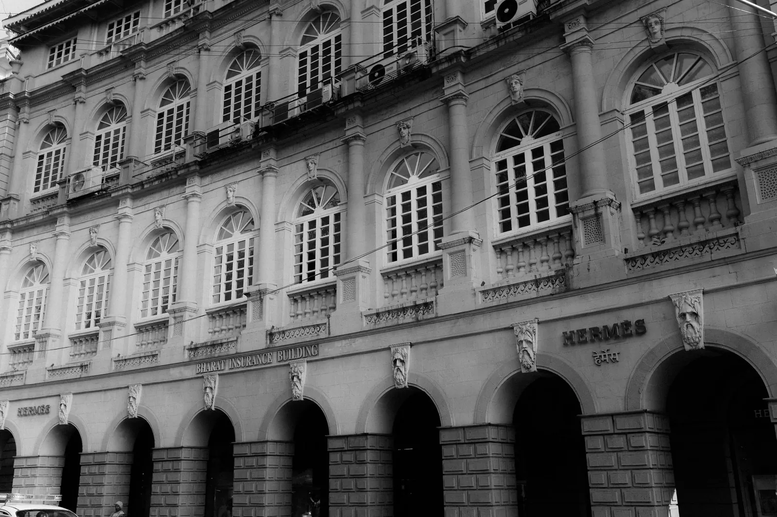 Black and white photo of the Bharat Insurance Building showcasing colonial architecture. Stock photo illustrating Sri Lotus Developers and Realty's new order story.