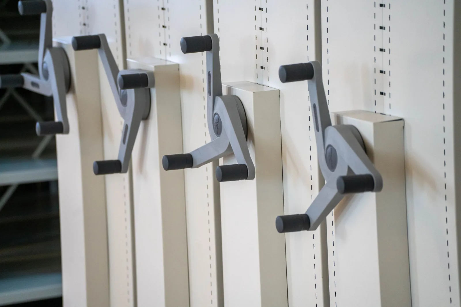 Close-up of industrial handle mechanisms for adjustable storage shelves in a neat arrangement. Stock photo illustrating Ola Electric Mobility's product launched story.