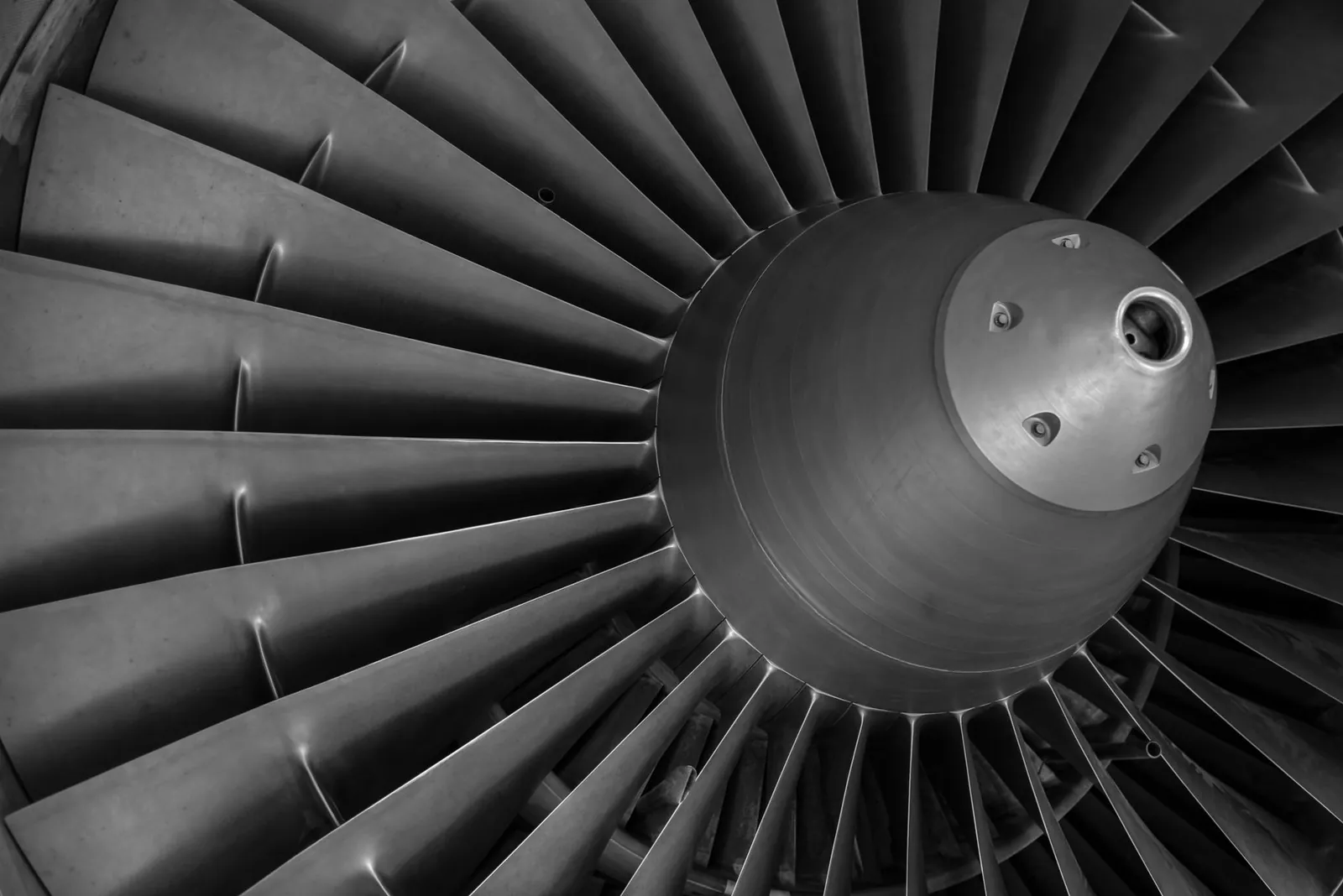 Detailed black and white image of an airplane turbine engine showcasing blades and craftsmanship. Stock photo illustrating Sansera Engineering's earning call story.