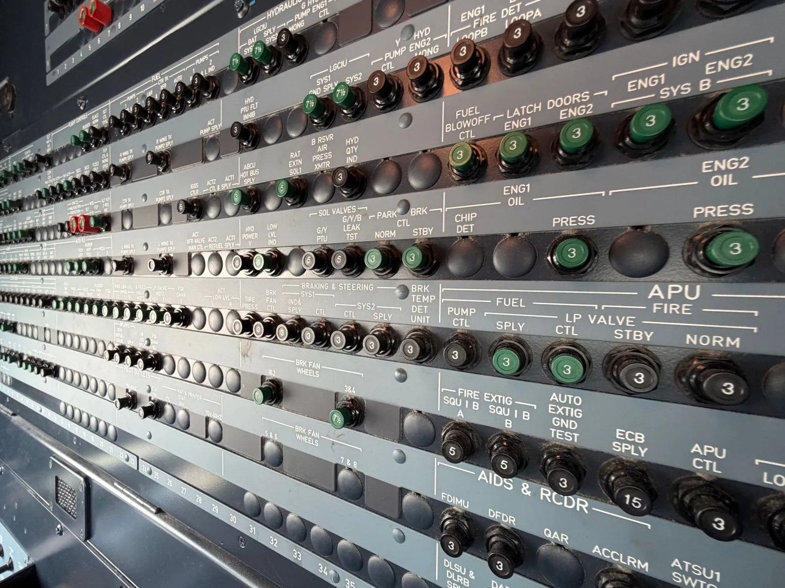 Detailed view of an airplane avionics control panel featuring numerous switches and indicators. Stock photo illustrating S&S Power Switchgear's new order story.