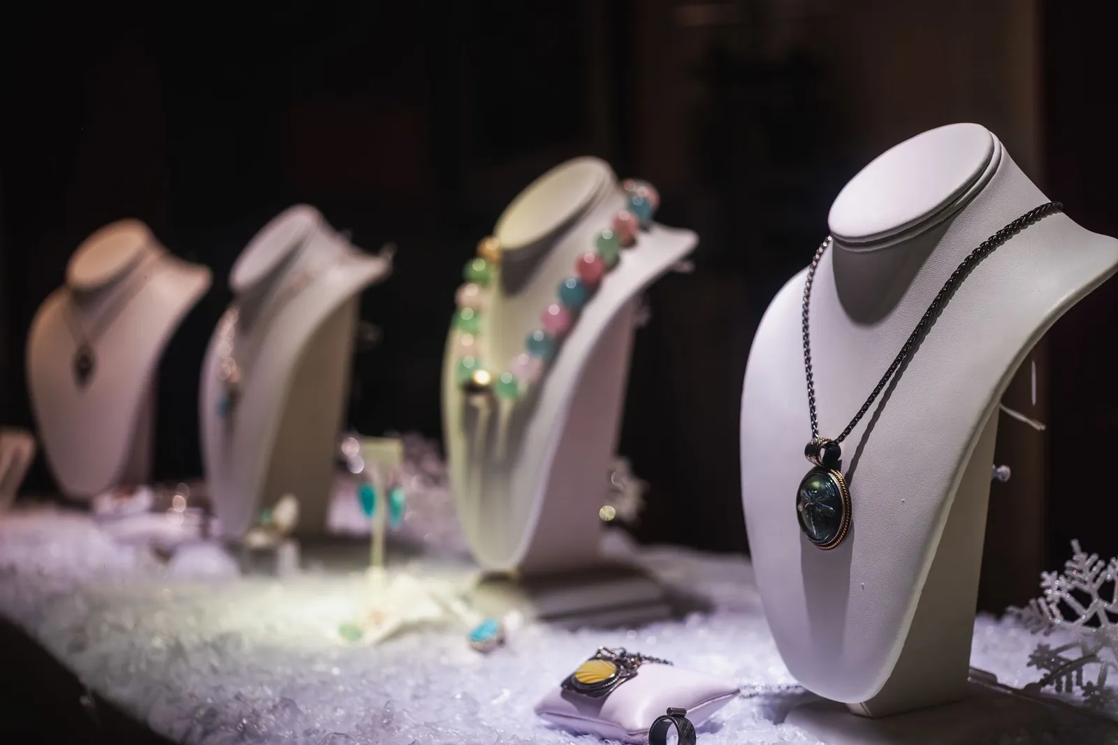 A refined display of luxurious necklaces on mannequins in a jewelry store. Stock photo illustrating Renaissance Global's expansion story.