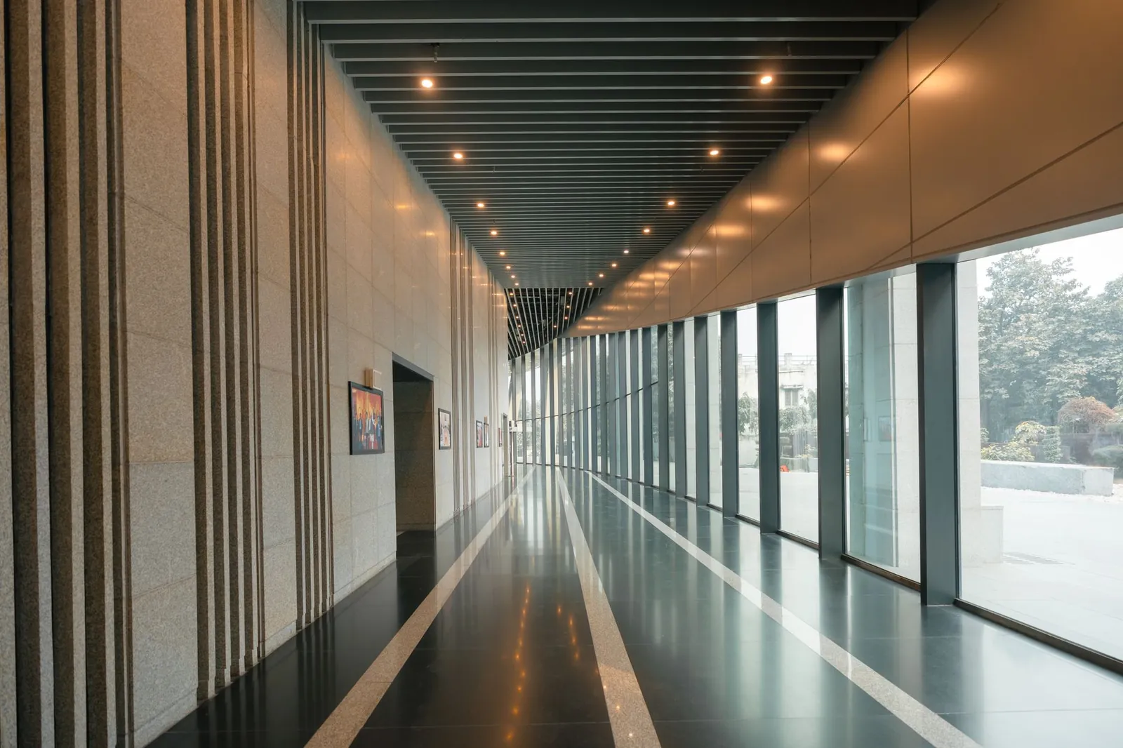 A sleek and modern interior corridor with large windows and sleek lines, suggesting luxury and corporate elegance. Stock photo illustrating Jana Small Finance Bank's earning call story.