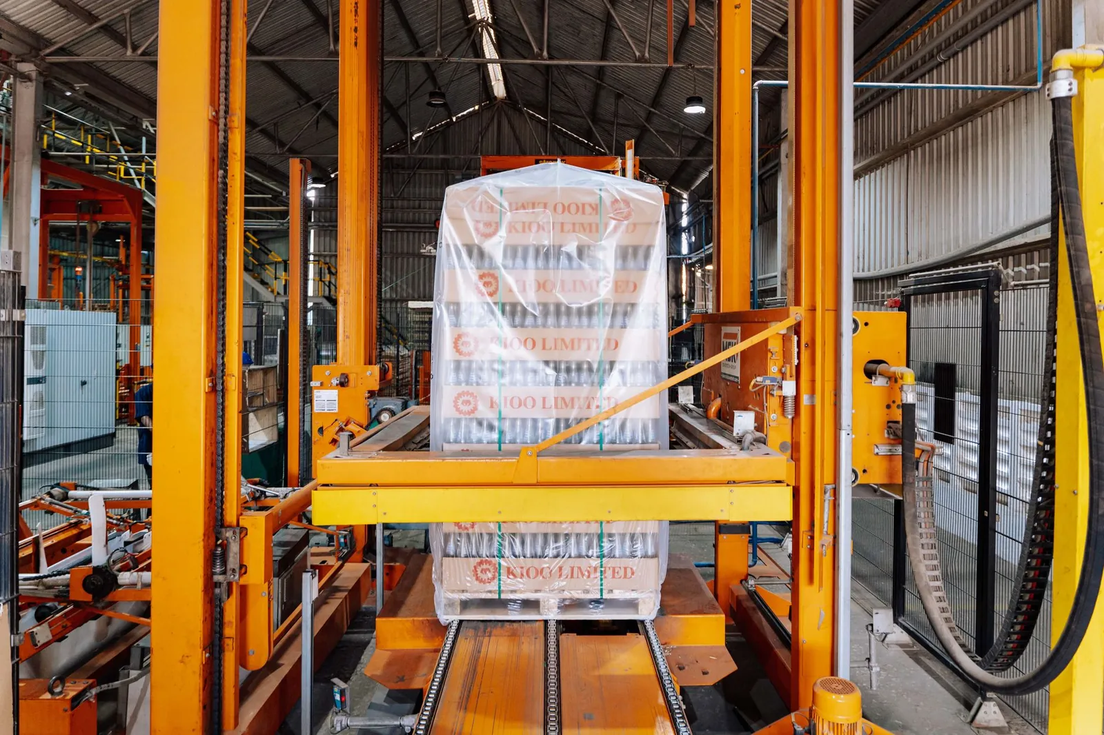 An industrial machine in a glass factory showcasing automated packaging in Dar es Salaam. Stock photo illustrating UFLEX's regulatory approval story.