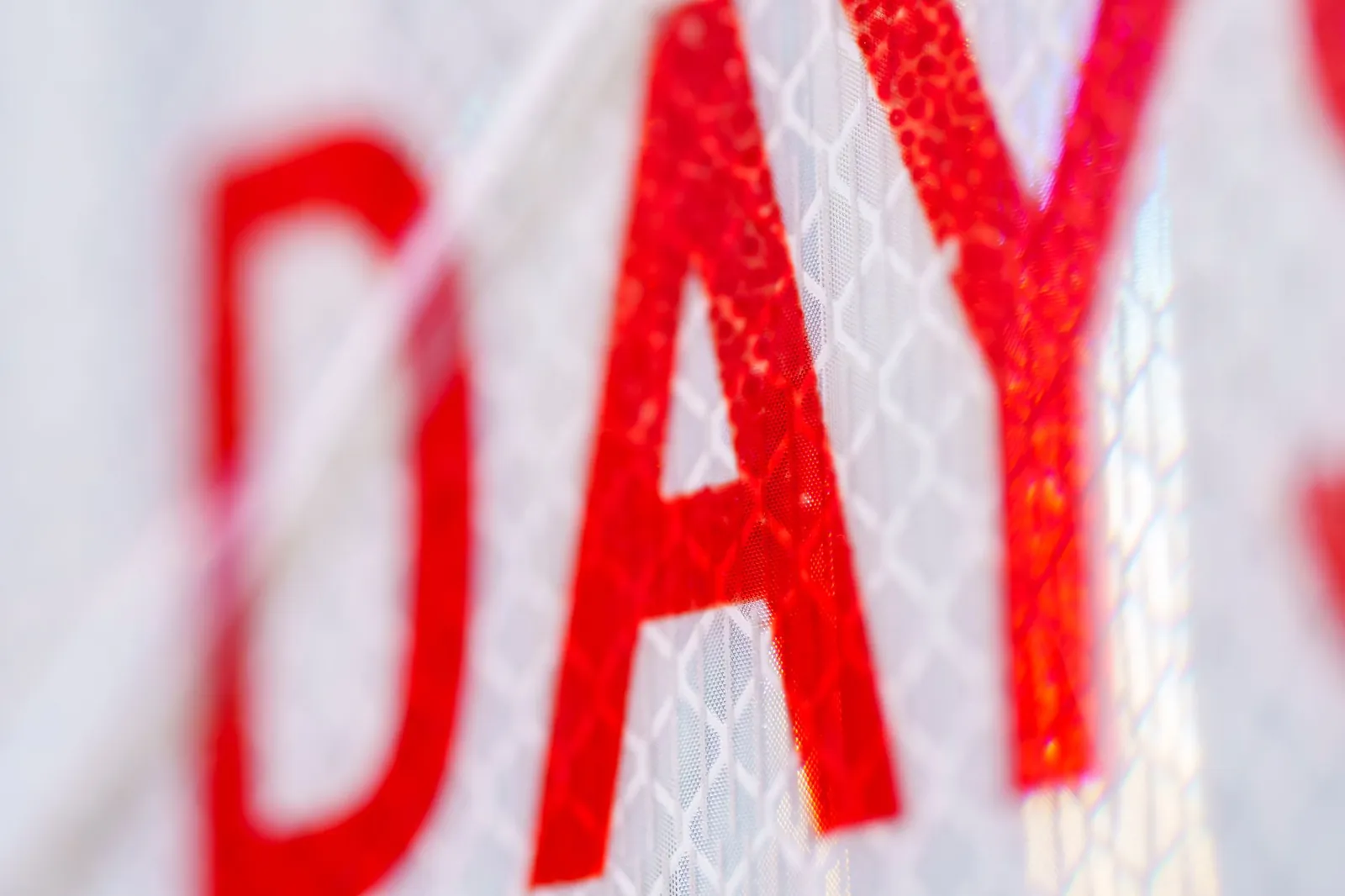 Macro shot of red text 'DAYS' on a reflective surface, artistic focus. Stock photo for the ALFA News guide: Working Capital Days: What They Reveal About a Company.