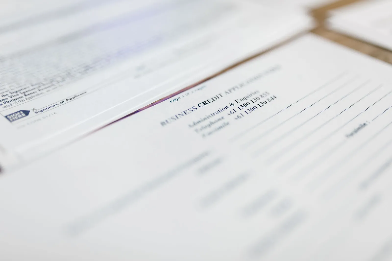 Focused image of business credit application papers, ideal for finance themes. Stock photo illustrating ESAF Small Finance Bank's financial results story.
