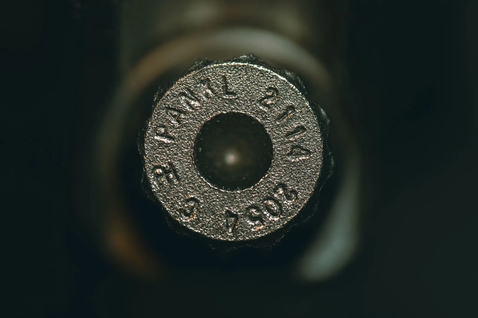 Detailed view of a metallic ammunition cartridge with engraved numbers. Stock photo illustrating Tembo Global Industries' partnership story.