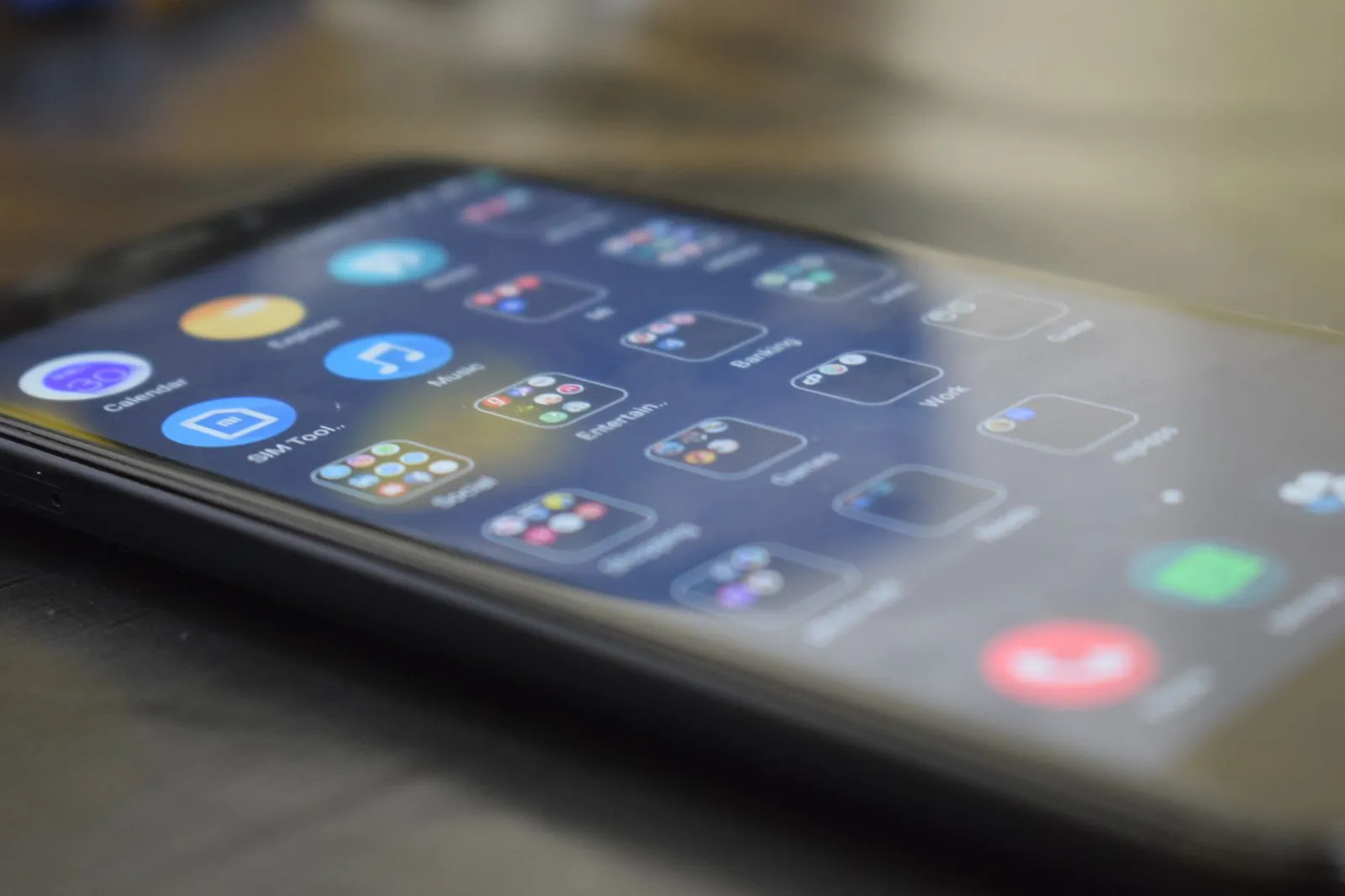 Close-up shot of a smartphone screen showing various app icons, indicating digital technology use. Stock photo illustrating Emerald Finance's earning call story.