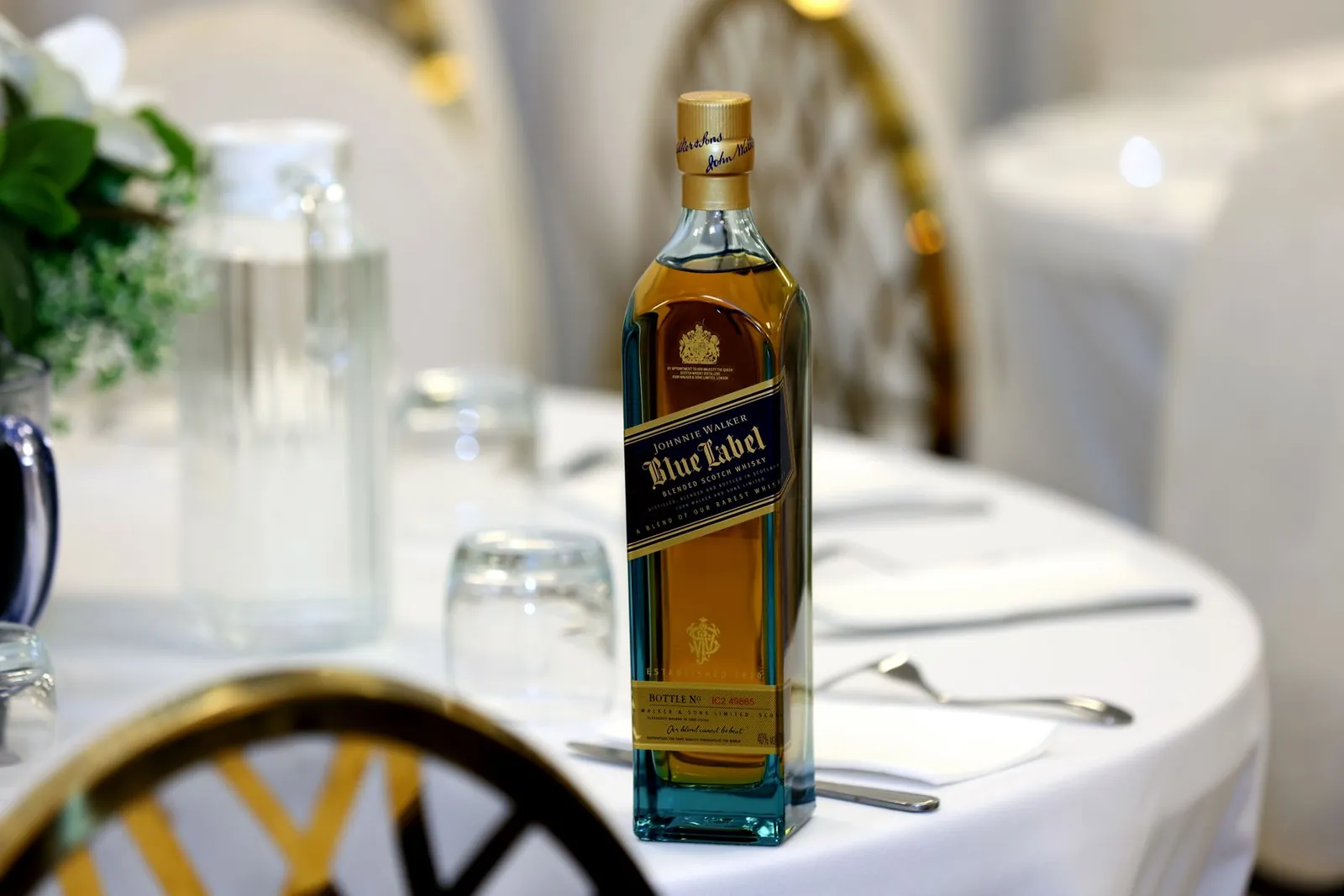 A premium whiskey bottle displayed on a decorated table, ideal for elegant celebrations. Stock photo illustrating Piccadily Agro Industries' product launched story.