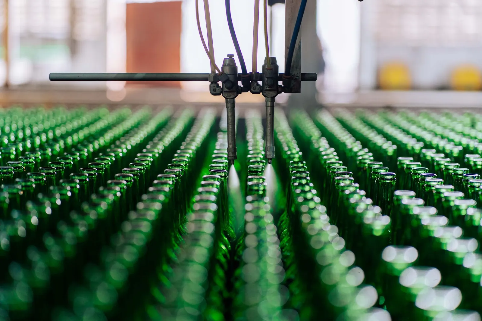 Glass bottles on an automated line in a factory, showcasing industrial glass making. Stock photo illustrating Hindustan Foods' earning call story.