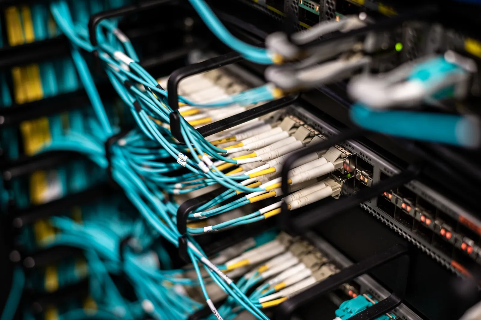 Numerous wires and cables mounted into server patch panel in modern data center. Stock photo illustrating TCC Concept's earning call story.