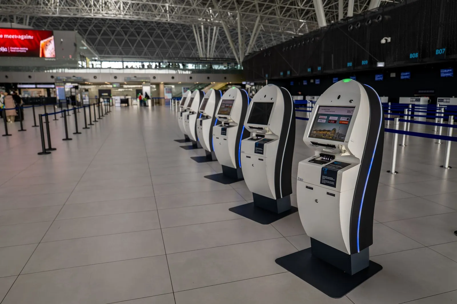 Wide view of an airport terminal in Zagreb featuring self-service check-in kiosks. Stock photo illustrating Infinity Infoway's product launched story.