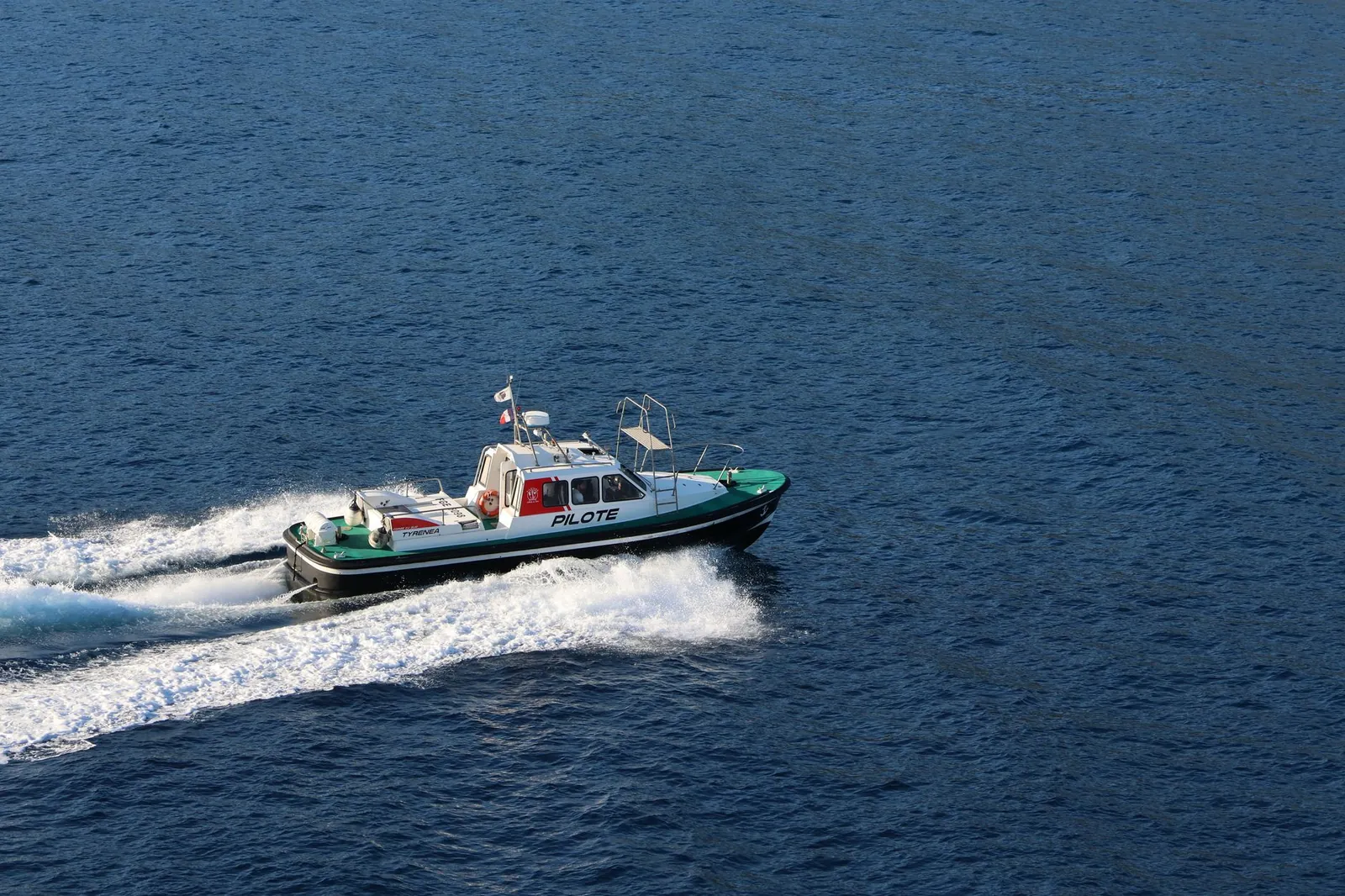 A dynamic shot of a pilot boat traveling swiftly over the ocean under a clear sky. Stock photo illustrating Sadhav Shipping's expansion story.
