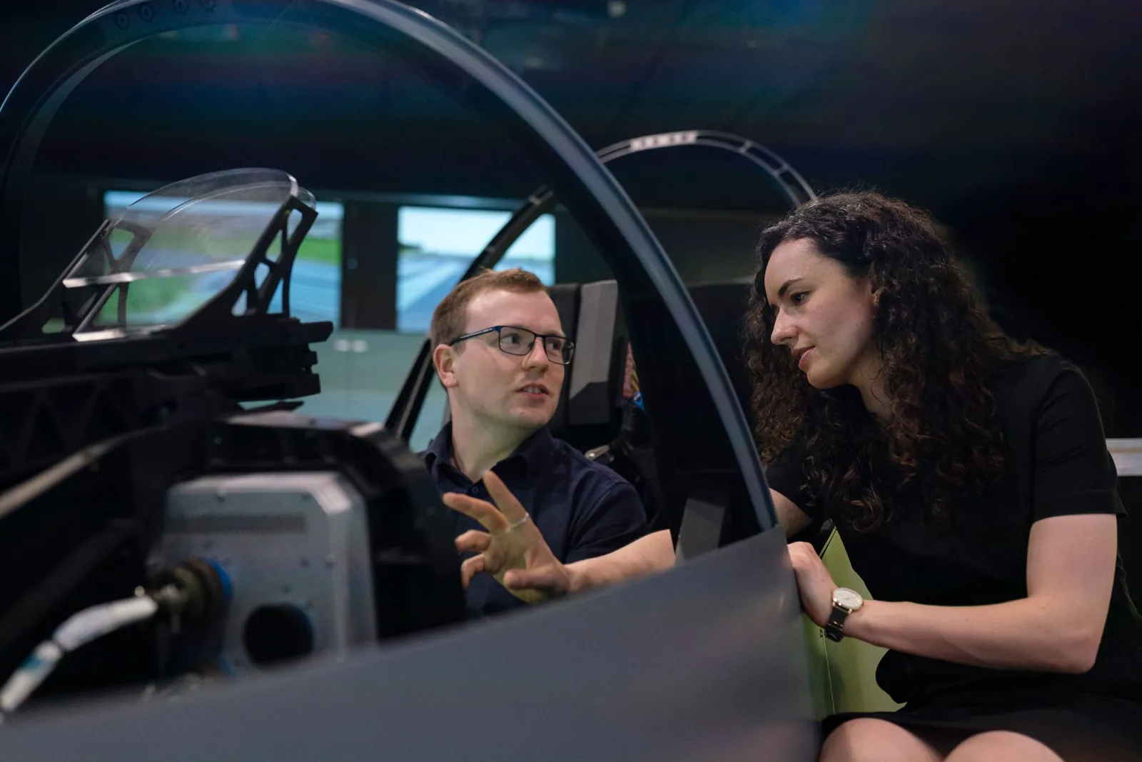 Engineers analyzing aircraft cockpit design during a simulation session. Stock photo illustrating Flywings Simulator Training Centre's fund raise story.