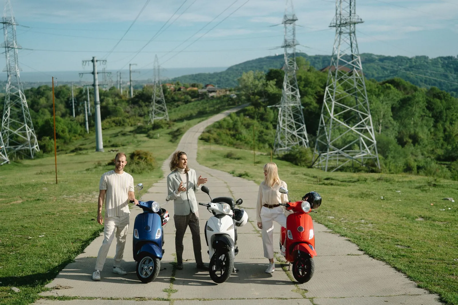 Three friends enjoying a countryside ride on scooters, perfect travel companions. Stock photo illustrating Ather Energy's fund raise story.