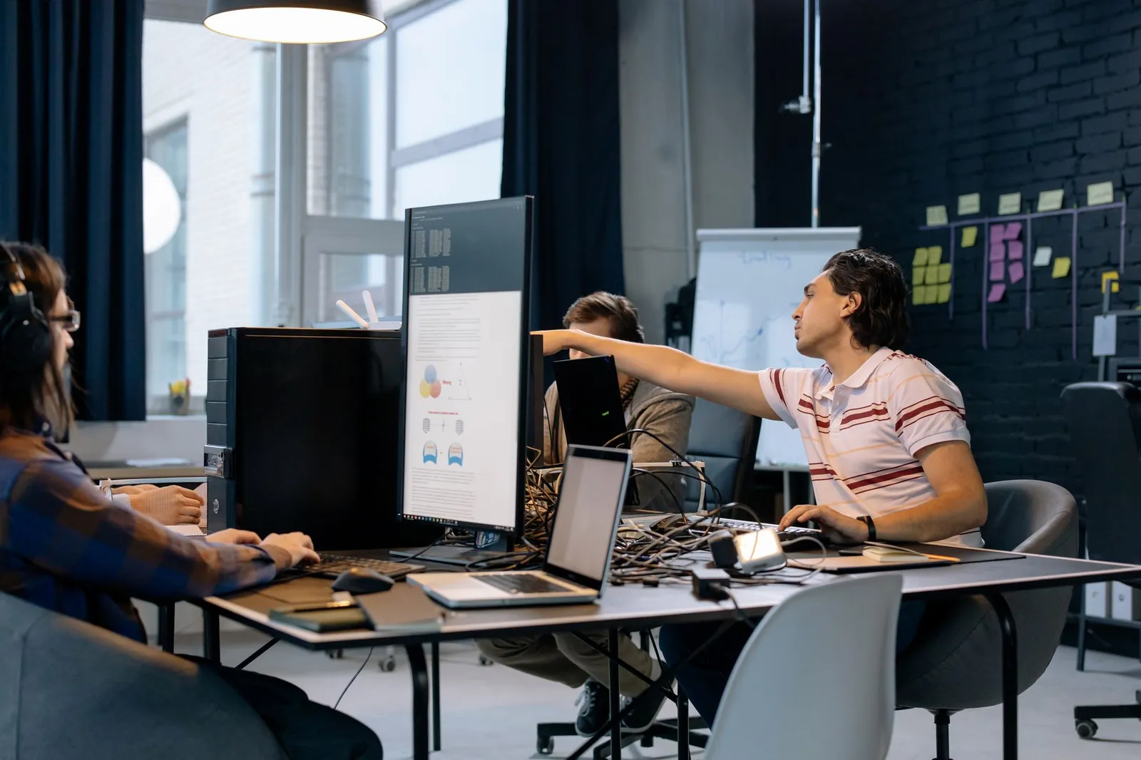 Group of young professionals working on software development in a creative indoor workspace. Stock photo illustrating Kellton Tech Solutions' fund raise story.