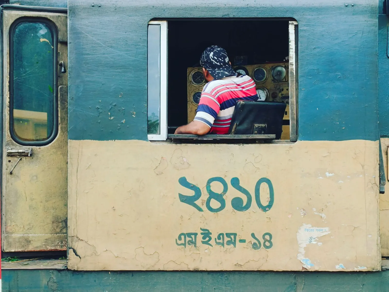 Train engineer inside a vintage locomotive cabin, showcasing railway history. Stock photo illustrating HBL Engineering's new order story.