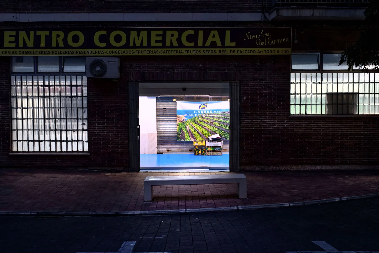A vibrant night view of a commercial center entrance in a city setting. Stock photo illustrating Chandan Healthcare's expansion story.