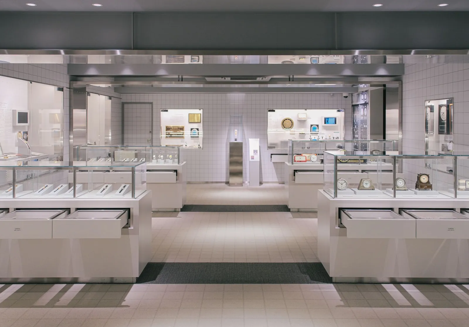 Luxurious watch showroom with elegant glass displays and modern design. Stock photo illustrating Yaashvi Jewellers' expansion story.