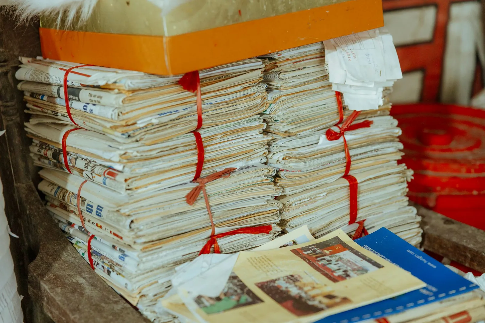 Bundles of newspapers bound together, showcasing vintage reading material. Stock photo for the ALFA News guide: How to Identify Material Information: A Guide for Investors.