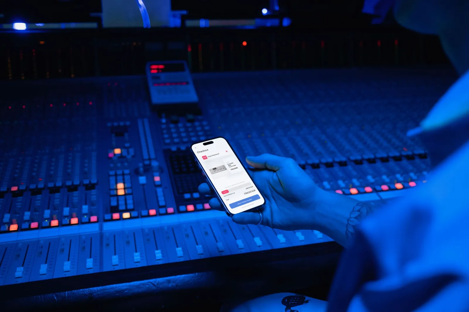 A smartphone displaying digital payment in a modern music studio setting. Stock photo illustrating Pine Labs' product launched story.