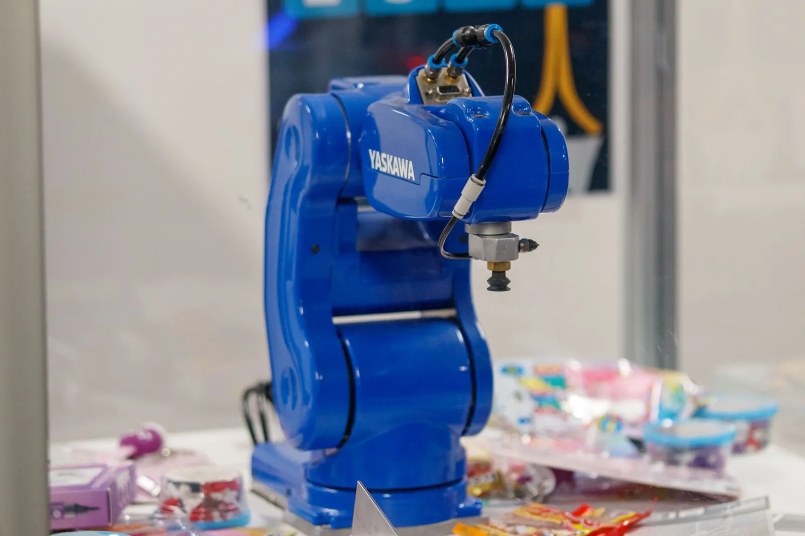 A blue Yaskawa industrial robot arm on display, showcasing advanced technology and robotics. Stock photo illustrating Sona BLW Precision Forgings' expansion story.