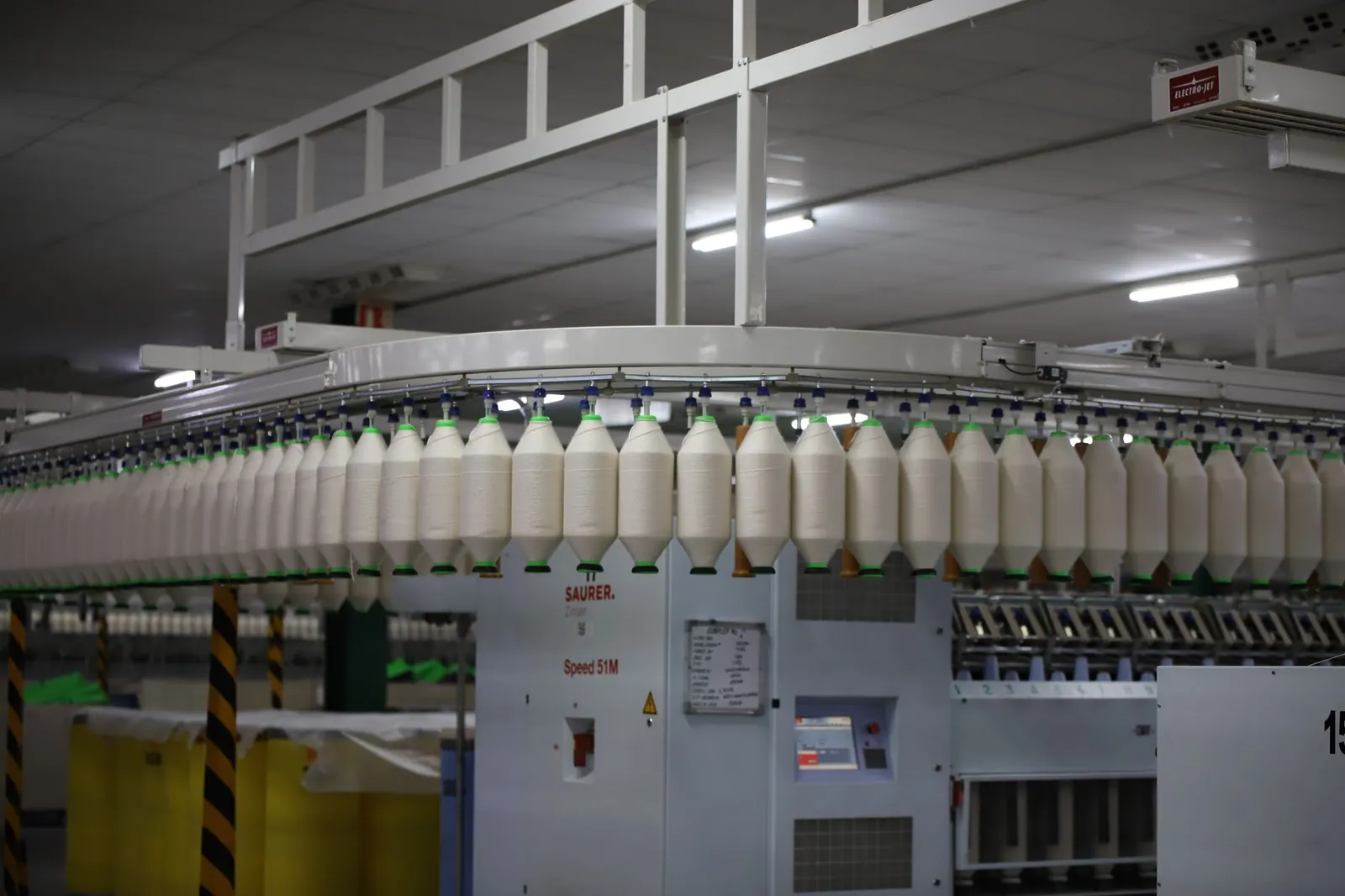 Industrial textile factory with yarn production line showcasing automated machinery for efficient manufacturing. Stock photo illustrating Rossell Techsys' fund raise story.