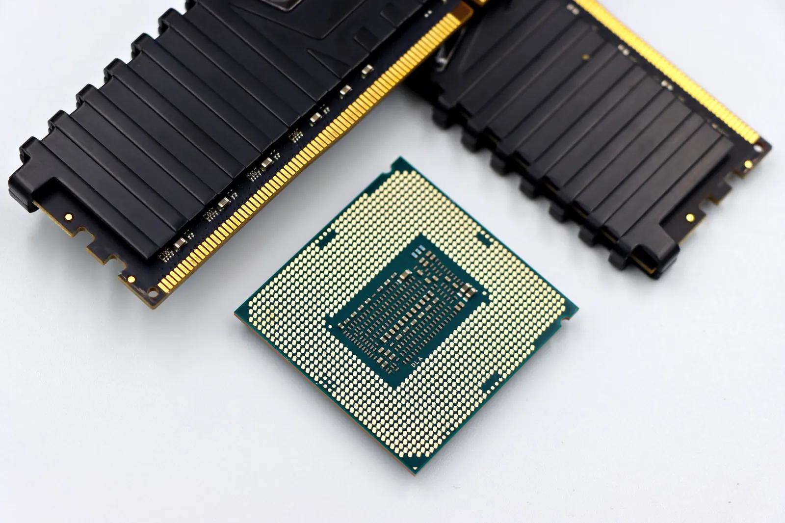 A CPU and RAM sticks displayed on a white surface, showcasing computer hardware components. Stock photo illustrating GNG Electronics' earning call story.