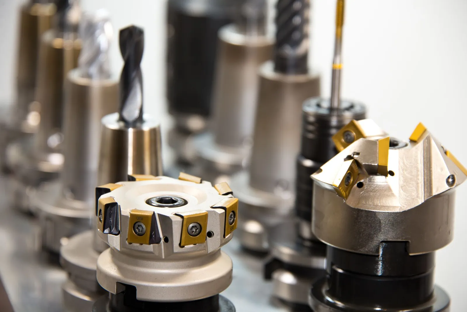 Detailed view of various metal drill bits and tools arranged in a workshop setting. Stock photo illustrating Shining Tools' new order story.