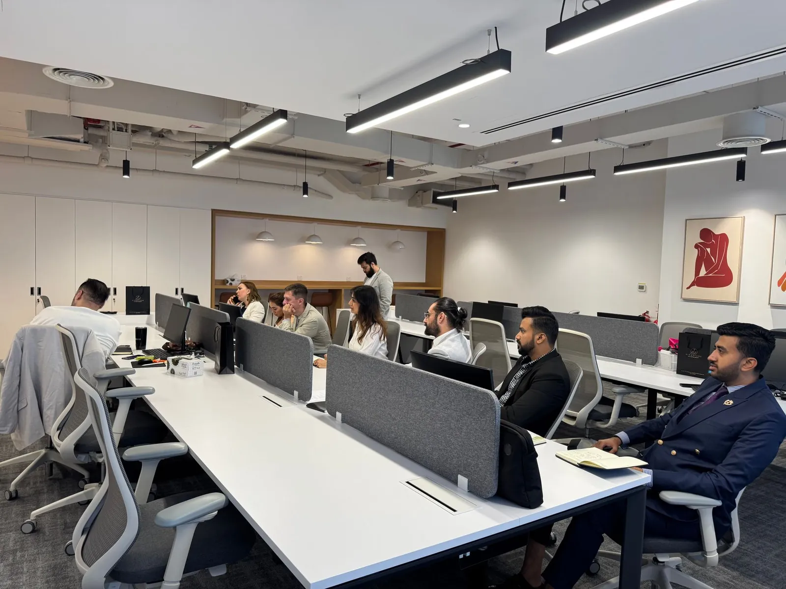 Diverse team working in a modern office setting with computers and collaborative spaces. Stock photo illustrating WeWork India Management's product launched story.
