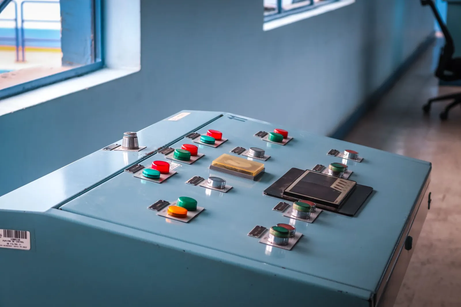 Close-up of an industrial control panel with colorful buttons in a factory setting. Stock photo illustrating Insolation Energy's earning call story.
