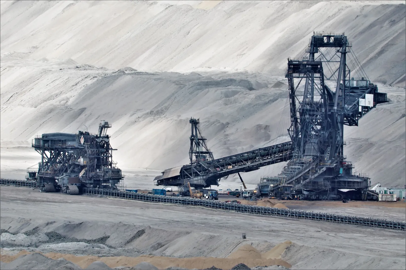 A large bucket wheel excavator operates in a vast industrial mining area, illustrating heavy machinery in action. Stock photo illustrating Bharat Coking Coal's partnership story.