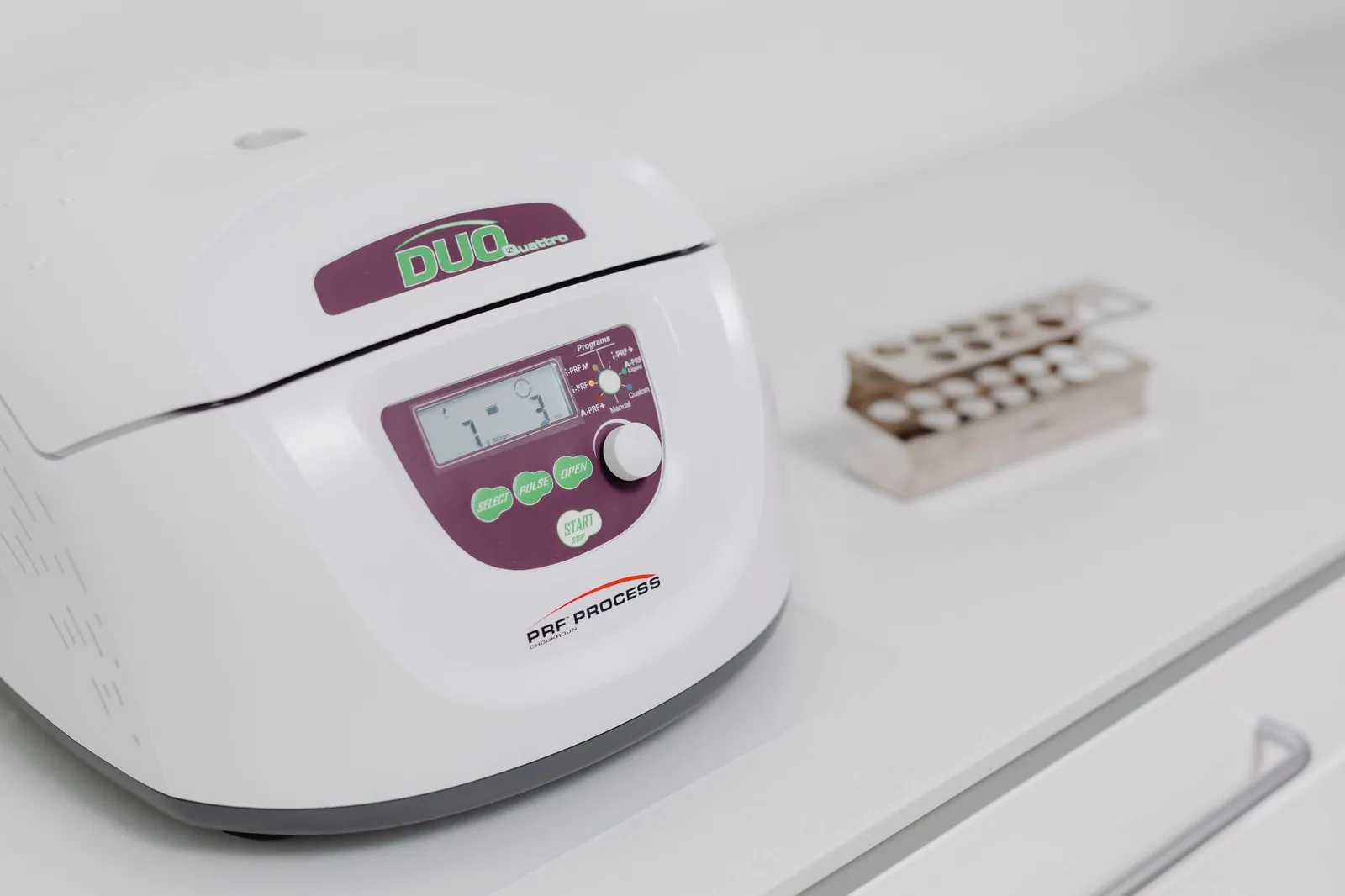 Close-up of a modern laboratory centrifuge on a sterile white surface, used in medical testing. Stock photo illustrating Accretion Pharmaceuticals' financial results story.