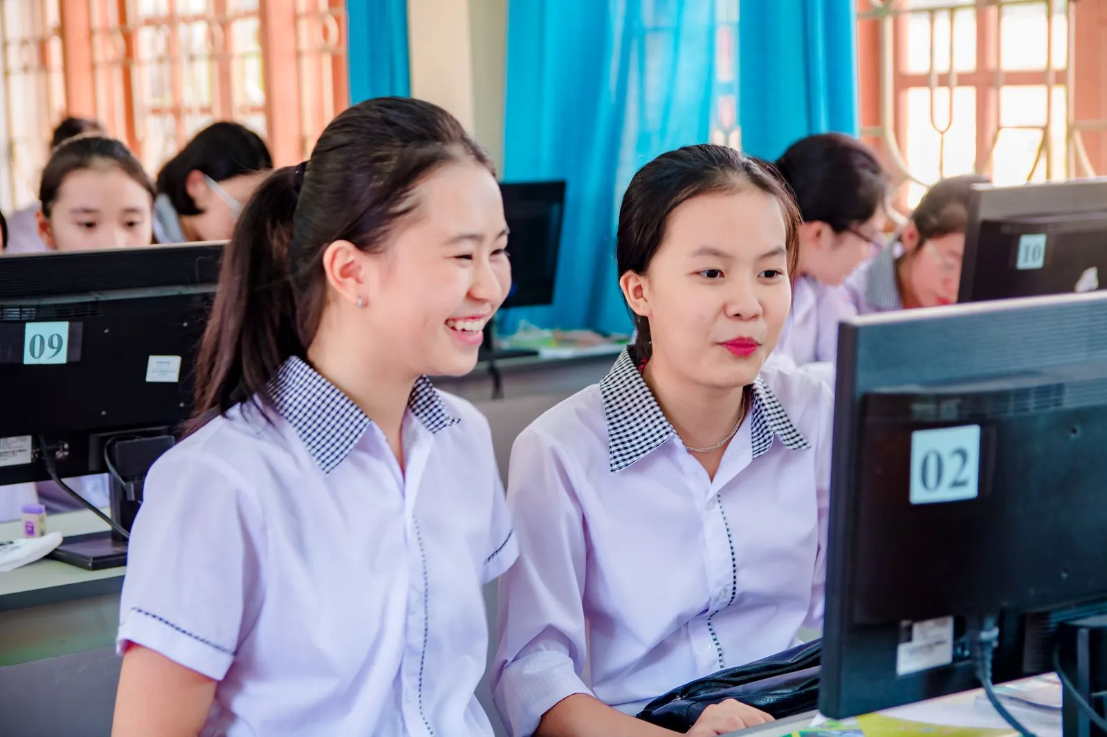 High school students collaborating on computers in a classroom setting. Stock photo illustrating KS Smart Technologies' new order story.