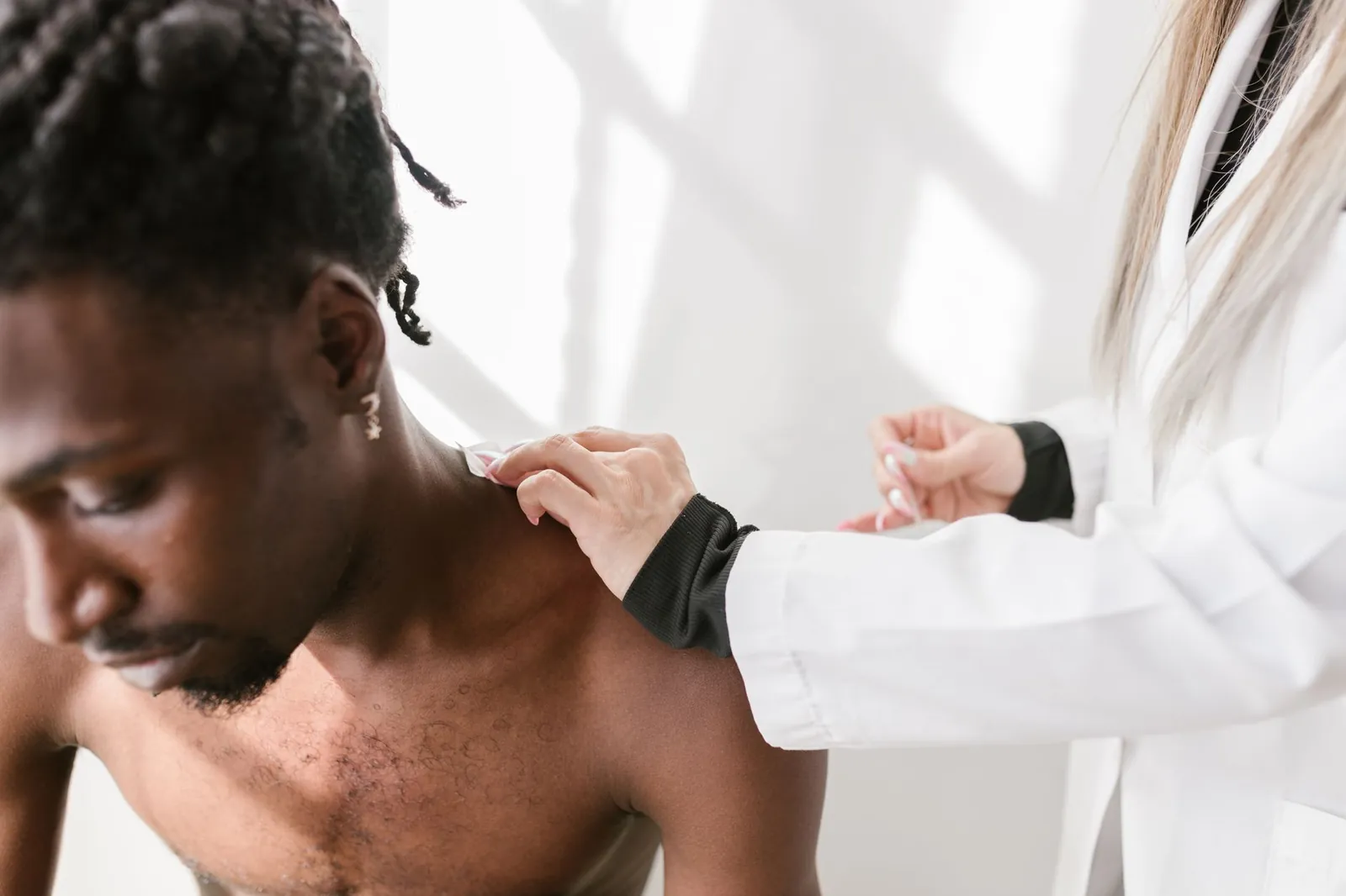 Close-up of a man receiving a shoulder massage for pain relief indoors. Stock photo illustrating Jeena Sikho Lifecare's product launched story.