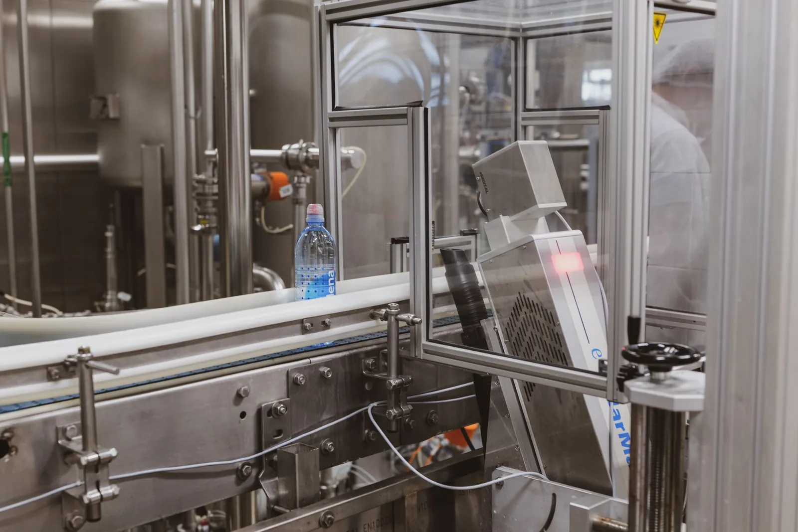 Close-up of a plastic bottle in a modern factory bottling production line. Stock photo for the ALFA News guide: How to Track Bulk Deals in Indian Stocks.