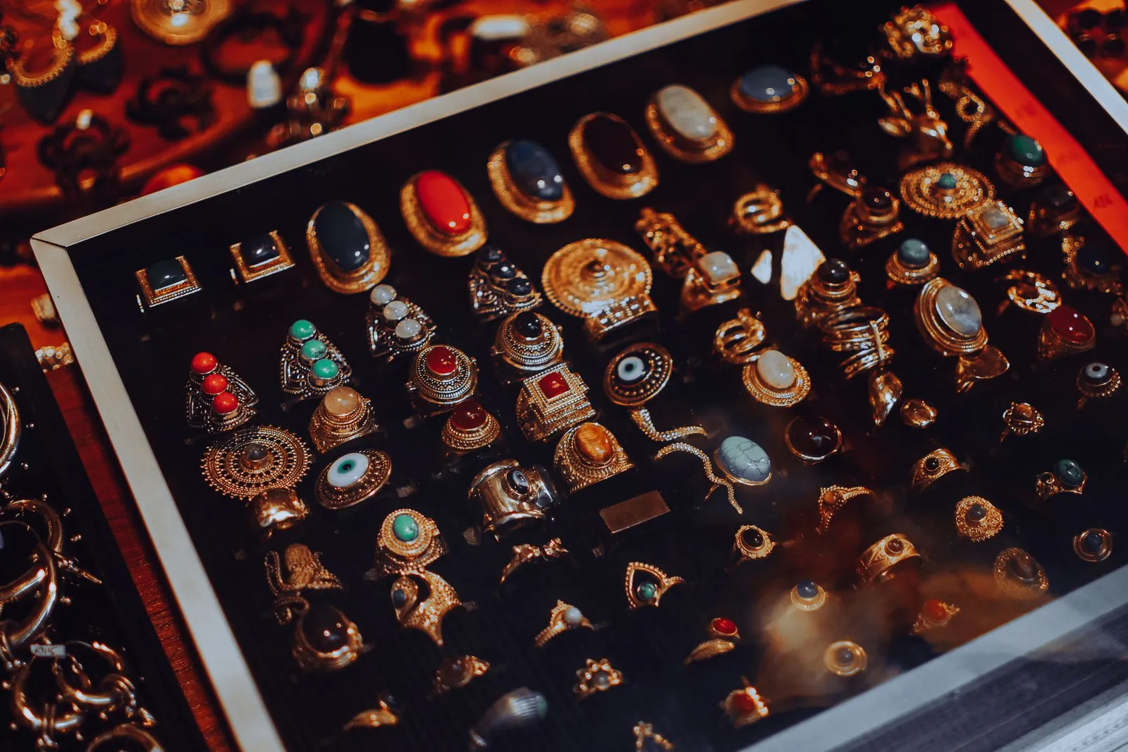Showcase of vintage jewelry with ornate designs in a glass display case. Stock photo illustrating Sky Gold and Diamonds' earning call story.