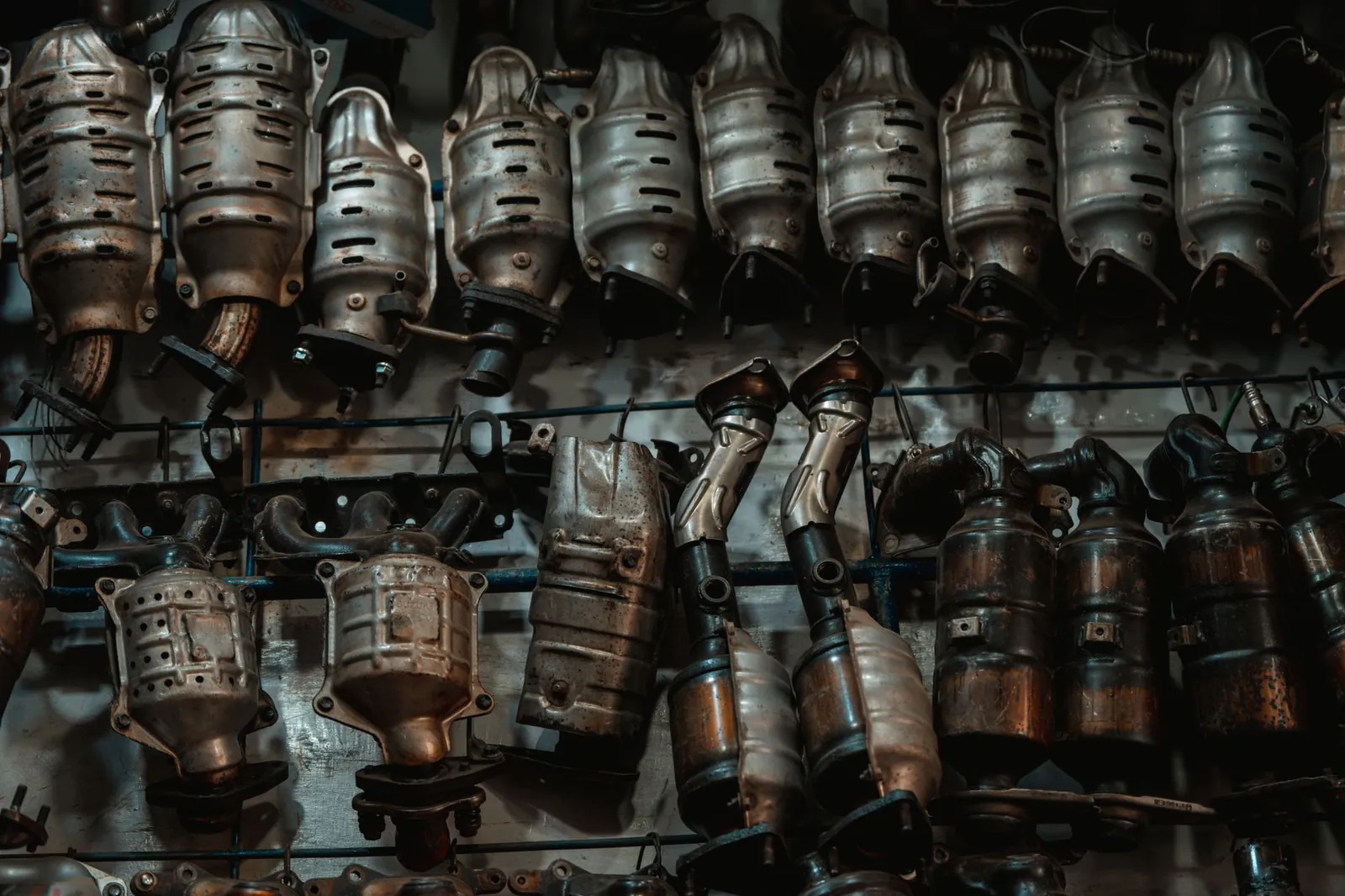 Rows of used catalytic converters in an automotive workshop setting. Stock photo illustrating Belrise Industries' fund raise story.